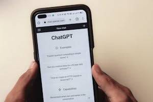 Webpage of ChatGPT, a prototype AI chatbot, is seen on the website of OpenAI, on a smartphone. Examples, capabilities, and limitations are shown.